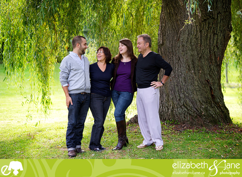 Family Photo: family of four laughing under the tree