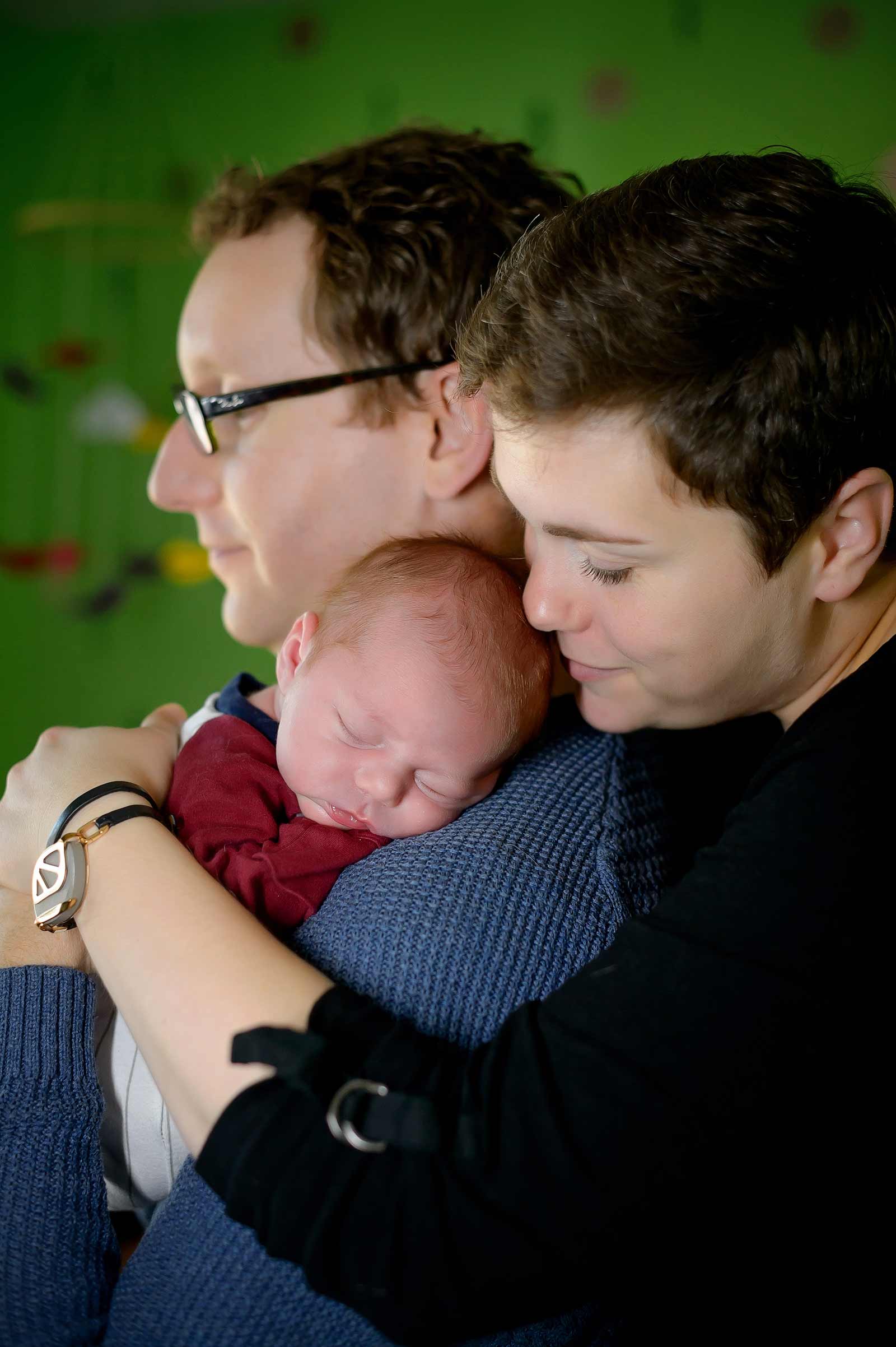 Chester sleeping on his Dad while is Mom cuddled him in Ottawa at his baby session.