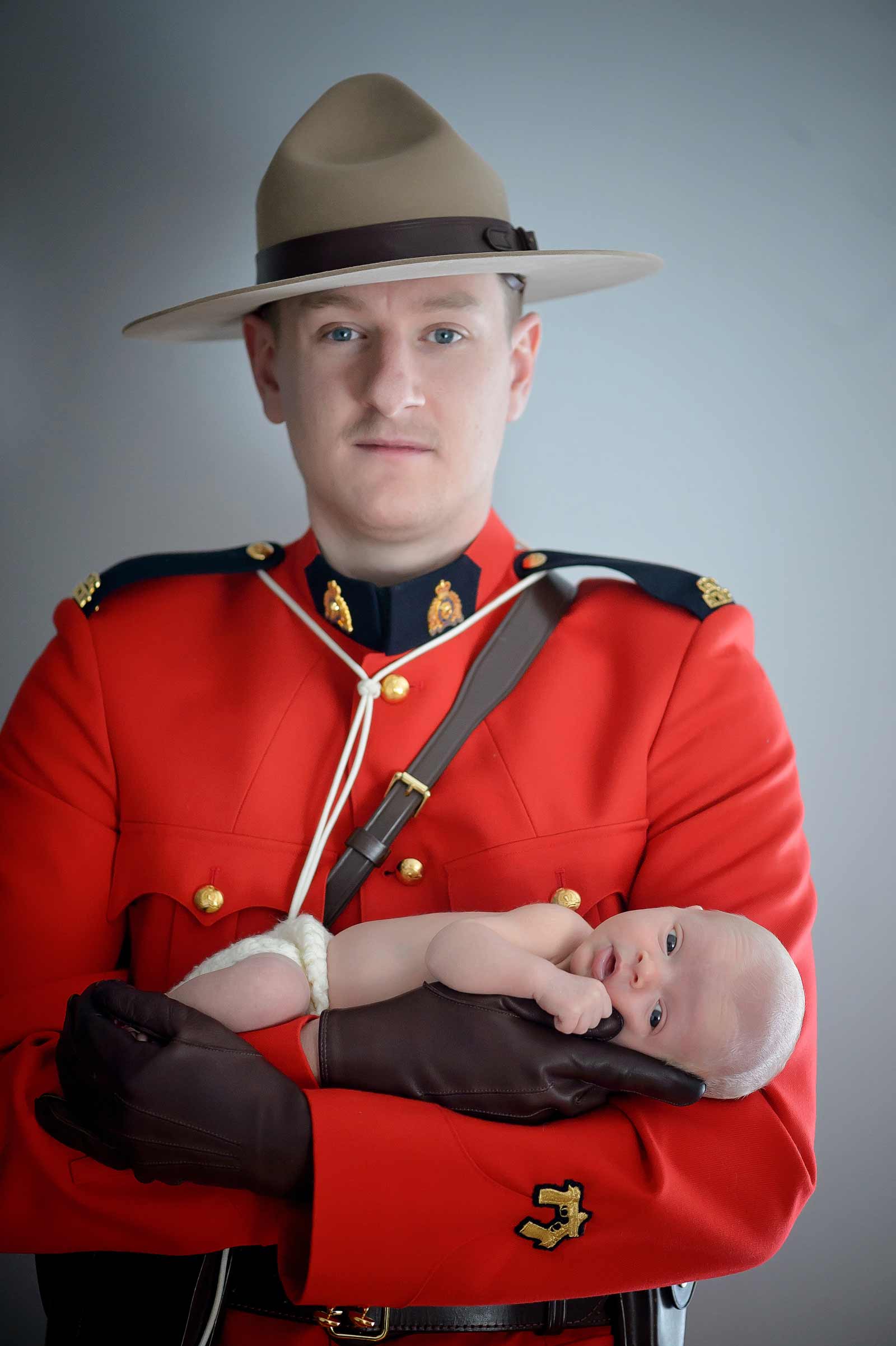 RCMP Father holding his newborn son in uniform